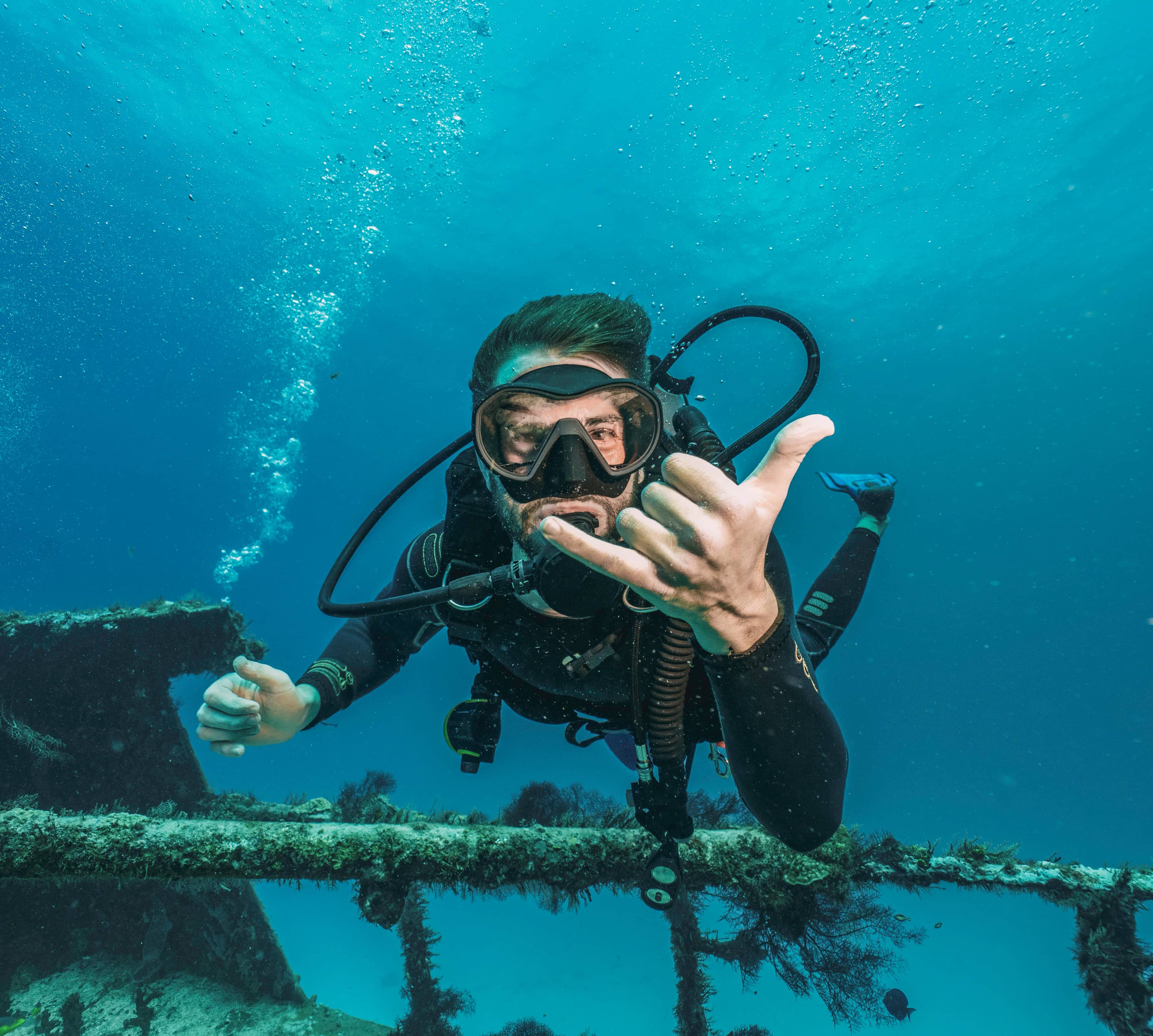 Professional scuba diver diving in a shipwreck