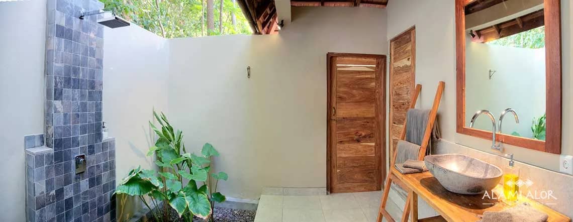 A partially-covered outdoor bathroom with shower and sink at Alami Alor resort. A partially-covered outdoor bathroom with shower and sink at Alami Alor resort.