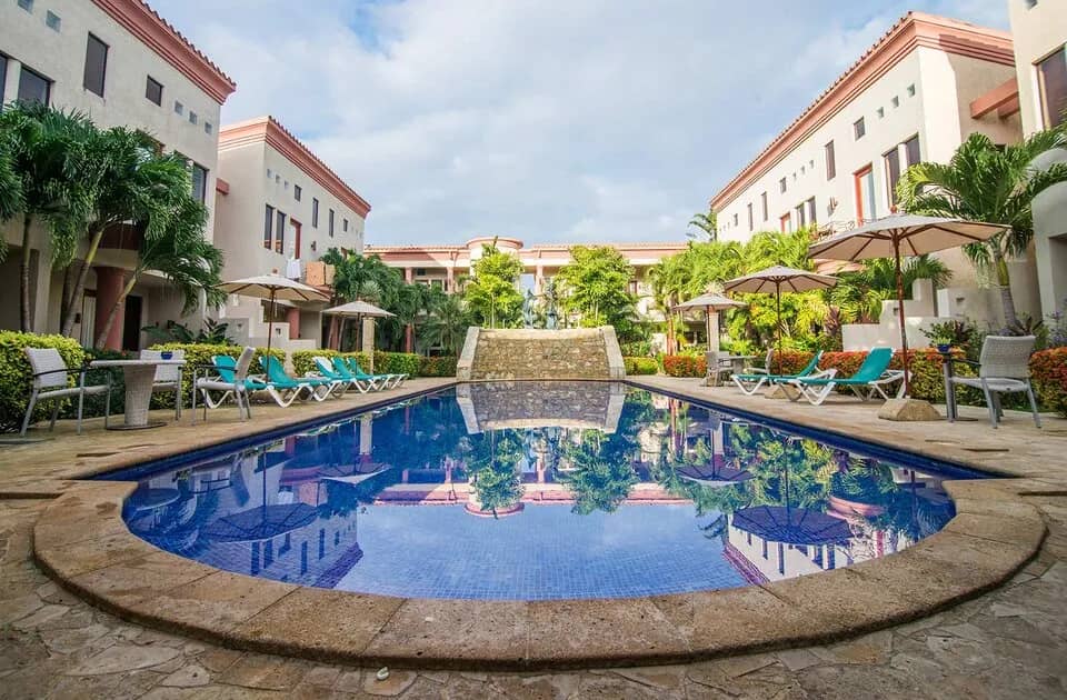 A pool in the middle of buildings at Las Sirenas by Mayan Princess Roatan A pool in the middle of buildings at Las Sirenas by Mayan Princess Roatan