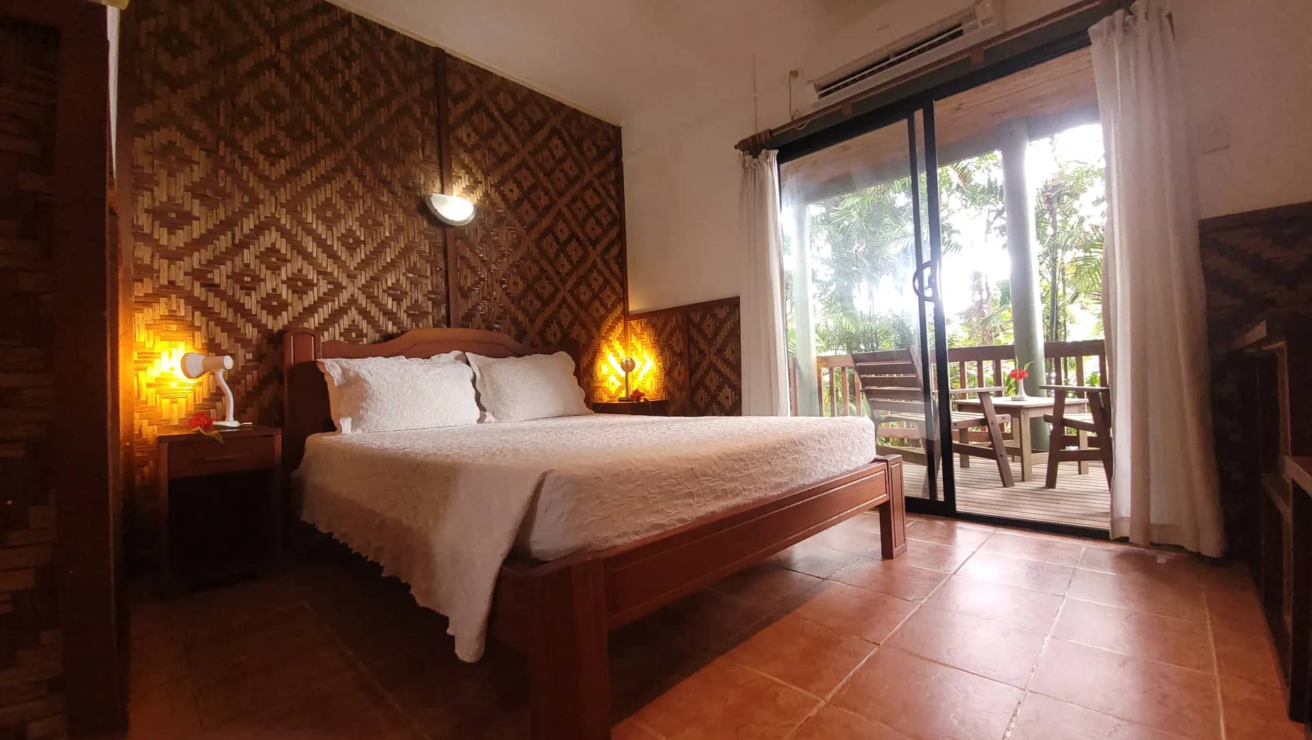 A bed in a deluxe room at Tufi Resort Papua New Guinea A bed in a deluxe room at Tufi Resort Papua New Guinea