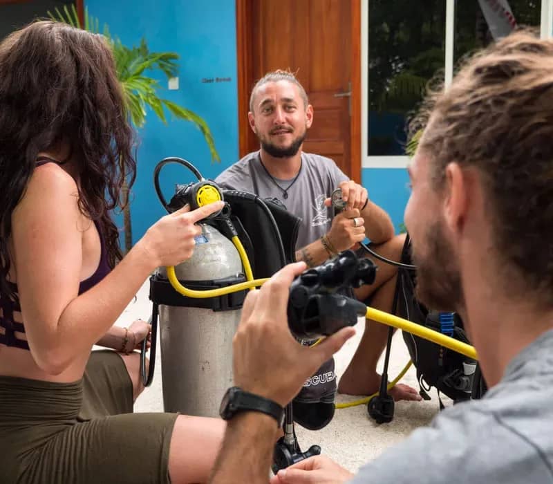 An instructor helping divers gear up An instructor helping divers gear up
