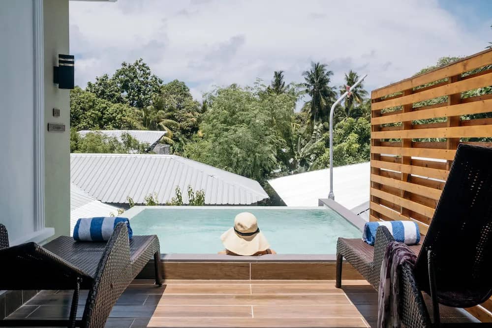 A relaxing swimming pool with two lounge chairs A relaxing swimming pool with two lounge chairs