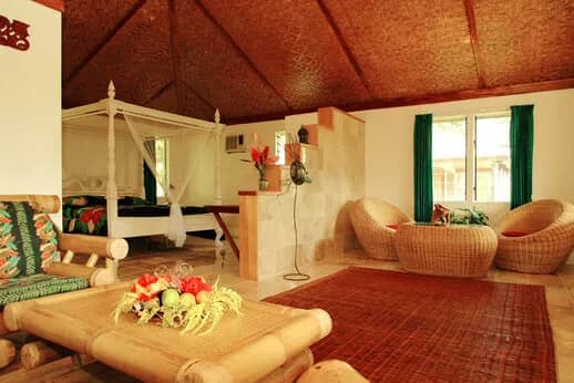 A room with a large bed and seating areas. A room with a large bed and seating areas.