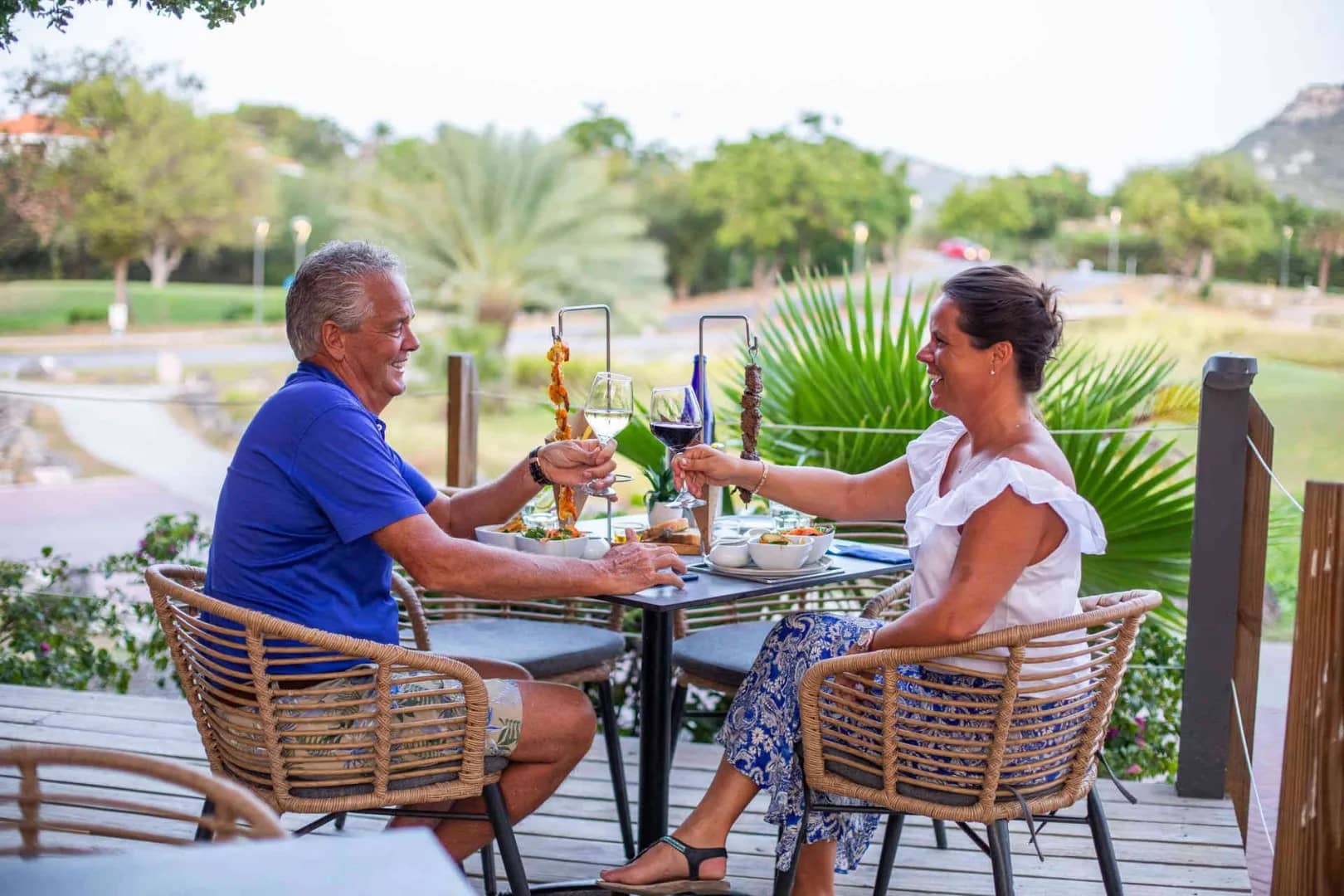 Guests enjoy a meal overlooking the gardens Guests enjoy a meal overlooking the gardens