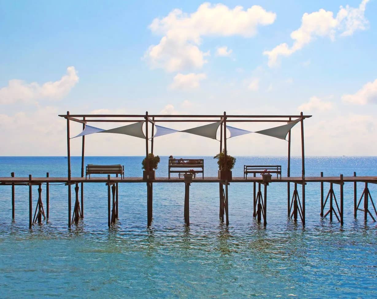 A lounge area sits on stilts over the sea at Lankayan Island Resort A lounge area sits on stilts over the sea at Lankayan Island Resort